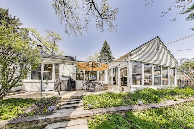 201 W Council Trl, Mount Prospect, IL 60056 - rear view of property featuring a chimney, a sunroom, and a patio area