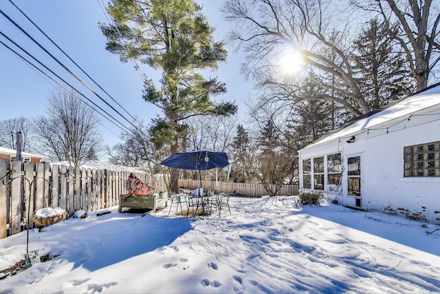 yard covered in snow featuring a fenced backyard