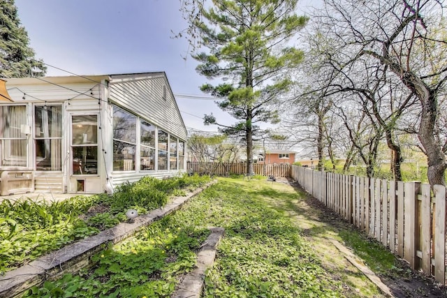 201 W Council Trl, Mount Prospect, IL 60056 - view of yard featuring a sunroom and a fenced backyard