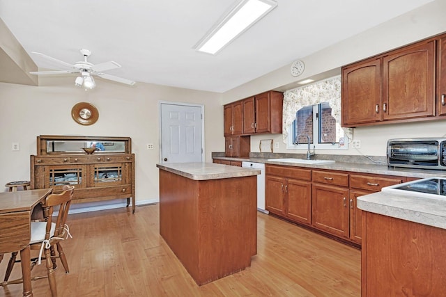 kitchen featuring sink, a center island, dishwasher, and light hardwood / wood-style flooring