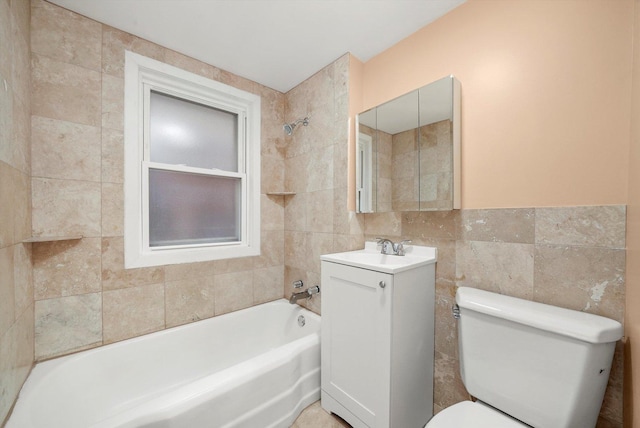 full bathroom with vanity, toilet, tiled shower / bath combo, and tile walls