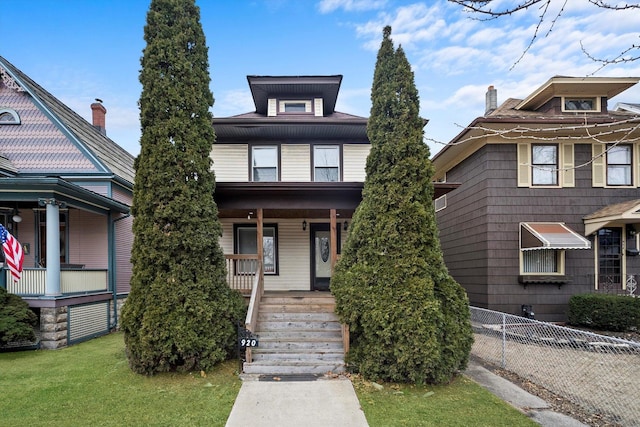 view of front of property featuring a porch and a front lawn