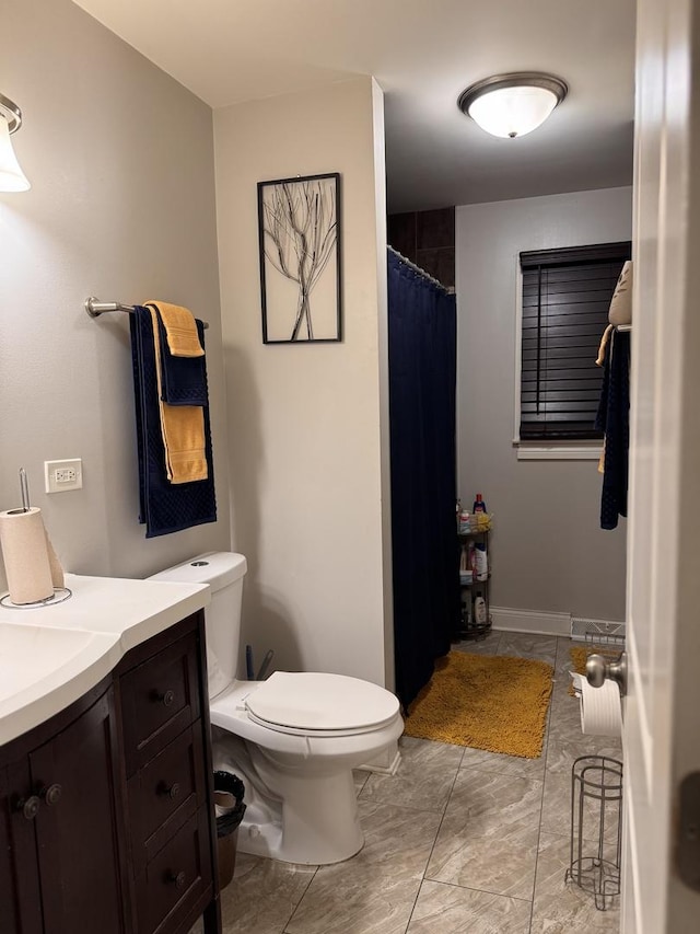 full bathroom with toilet and vanity