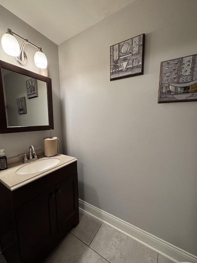 bathroom featuring tile patterned flooring, vanity, and baseboards