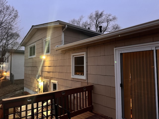 exterior entry at dusk with a wooden deck