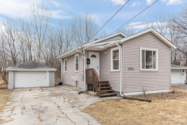 view of front of property with a garage and an outdoor structure