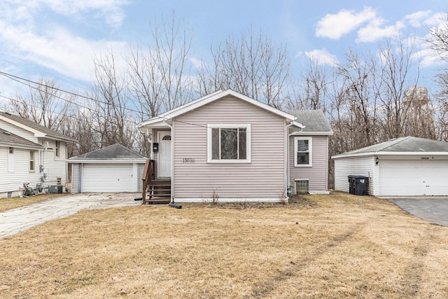 view of front of home with an outbuilding, a garage, and a front yard