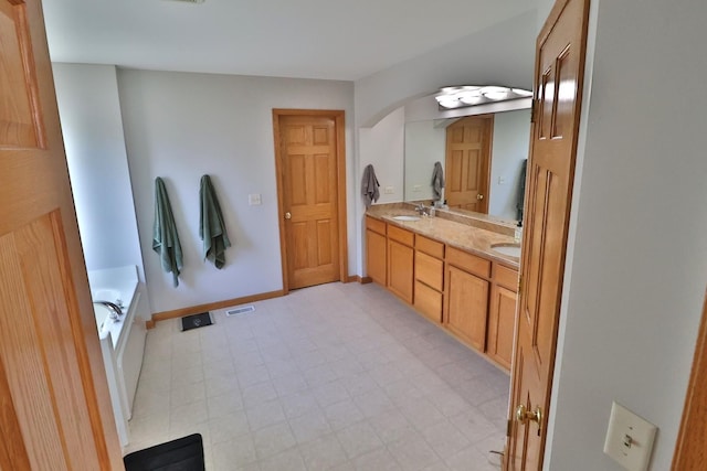 bathroom featuring vanity and a bathtub