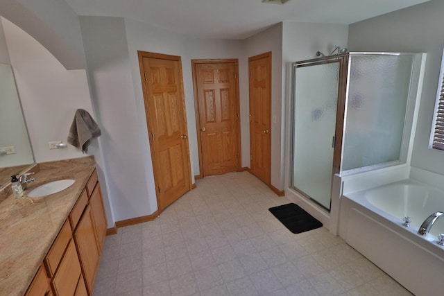 bathroom featuring vanity and shower with separate bathtub