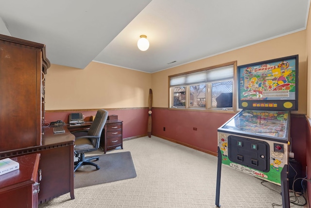 home office with baseboards and light colored carpet