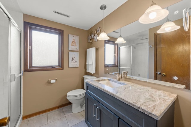 bathroom featuring visible vents, toilet, a stall shower, vanity, and tile patterned floors