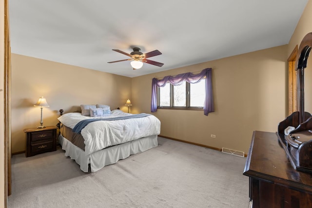 bedroom with visible vents, ceiling fan, light carpet, and baseboards