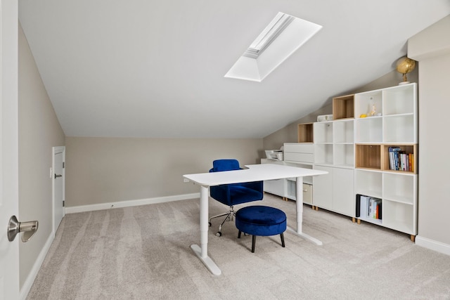 carpeted office with vaulted ceiling with skylight