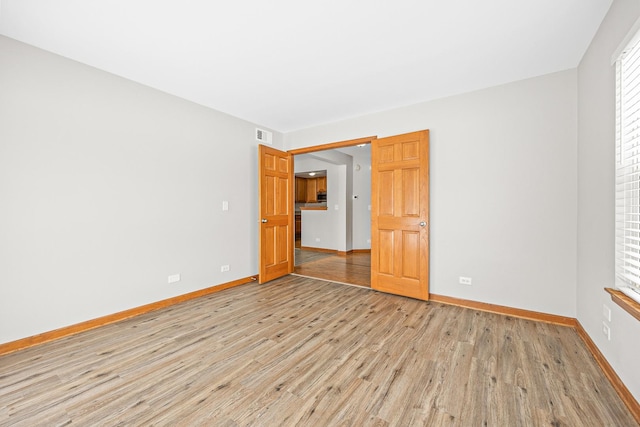 unfurnished room with light hardwood / wood-style flooring