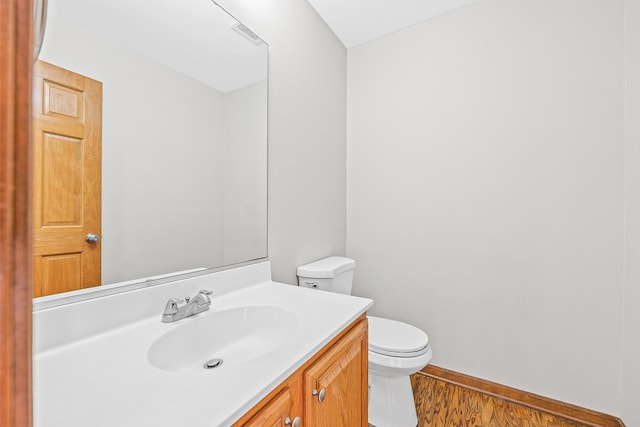 bathroom featuring hardwood / wood-style floors, vanity, and toilet