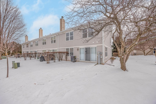 snow covered property featuring central air condition unit