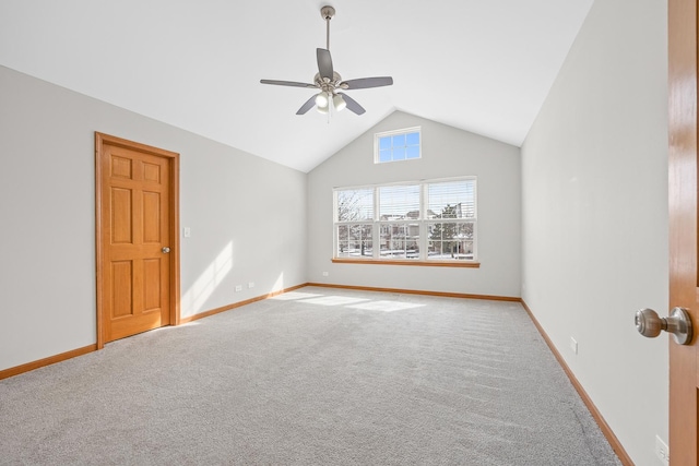 carpeted empty room featuring vaulted ceiling and ceiling fan