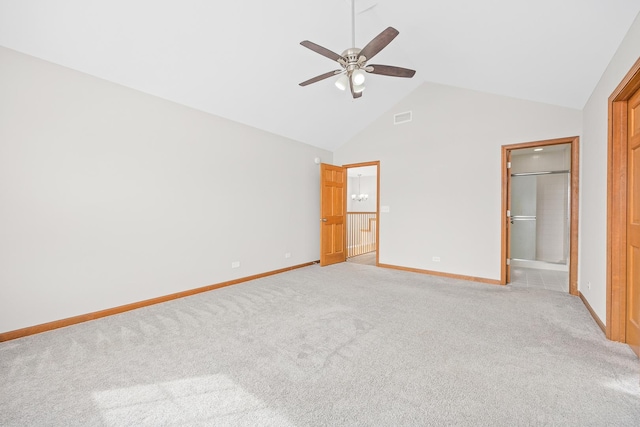 unfurnished bedroom featuring ceiling fan, high vaulted ceiling, ensuite bath, and light colored carpet