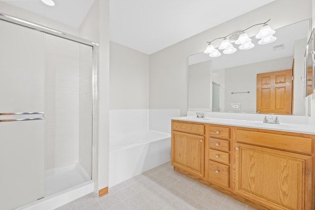 bathroom with vanity and shower with separate bathtub