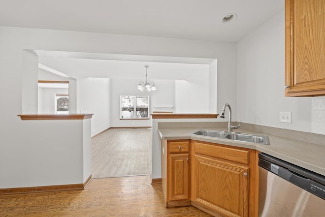 kitchen with a chandelier, sink, light wood-type flooring, decorative light fixtures, and stainless steel dishwasher