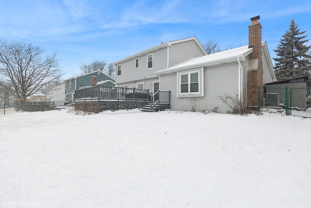 snow covered property featuring a deck