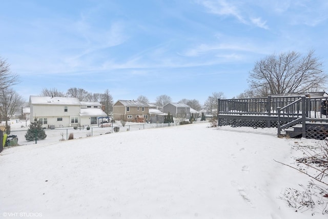 yard layered in snow featuring a wooden deck