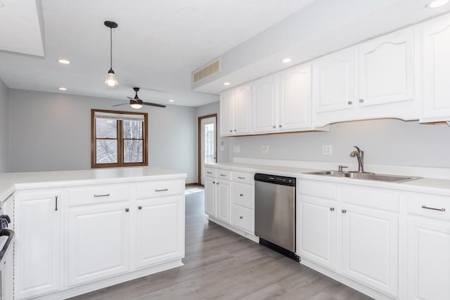 kitchen with ceiling fan, visible vents, stainless steel dishwasher, a sink, and white cabinetry