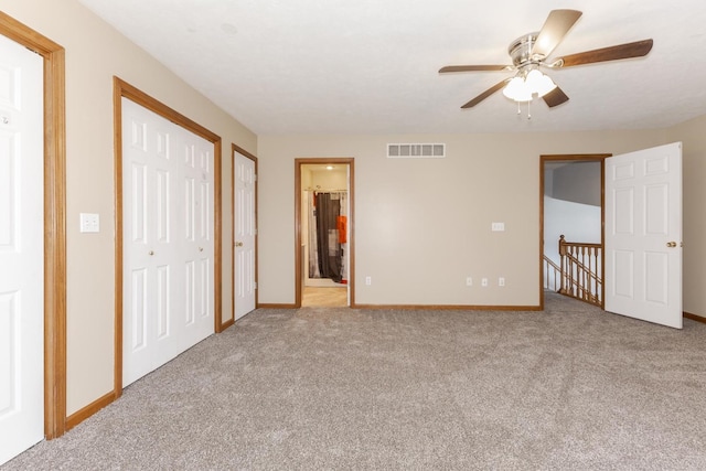 interior space featuring baseboards, carpet flooring, and visible vents