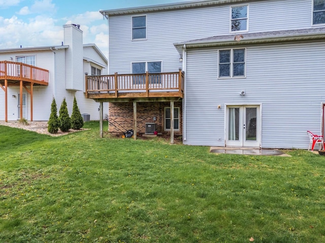 back of property featuring a yard, central AC, and a wooden deck