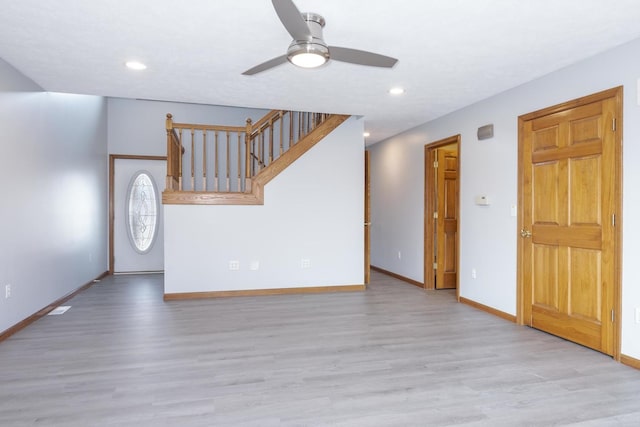 unfurnished living room with baseboards, a ceiling fan, wood finished floors, and recessed lighting
