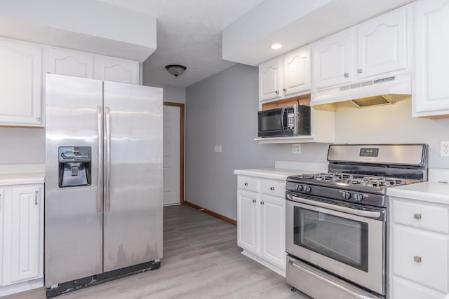 kitchen with baseboards, light countertops, white cabinetry, under cabinet range hood, and appliances with stainless steel finishes