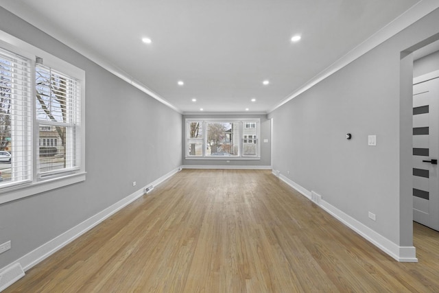 unfurnished living room featuring ornamental molding and light hardwood / wood-style floors