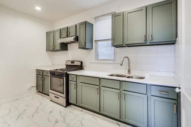 kitchen with stainless steel gas range, sink, and decorative backsplash