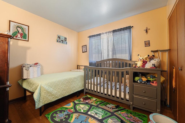 bedroom with dark hardwood / wood-style floors