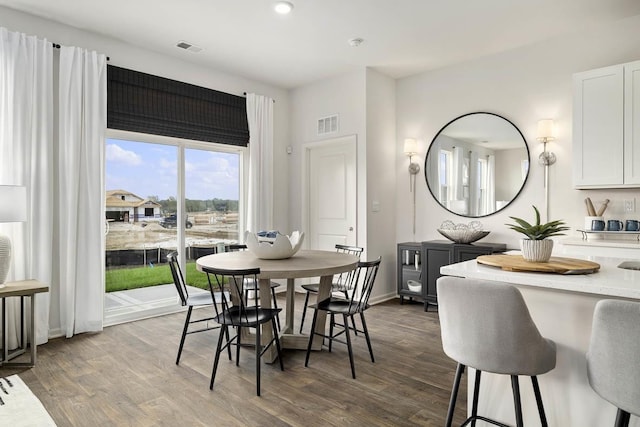 dining space with dark hardwood / wood-style flooring