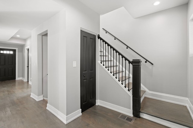 stairway featuring hardwood / wood-style floors