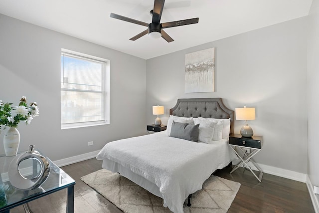bedroom with dark hardwood / wood-style floors and ceiling fan