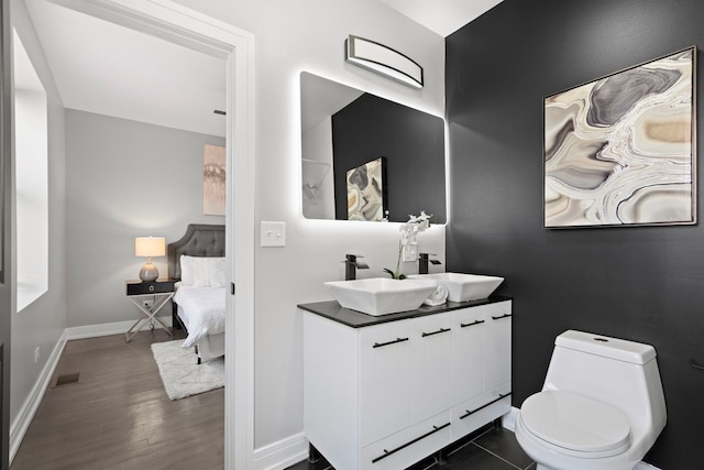 bathroom featuring hardwood / wood-style flooring, vanity, and toilet