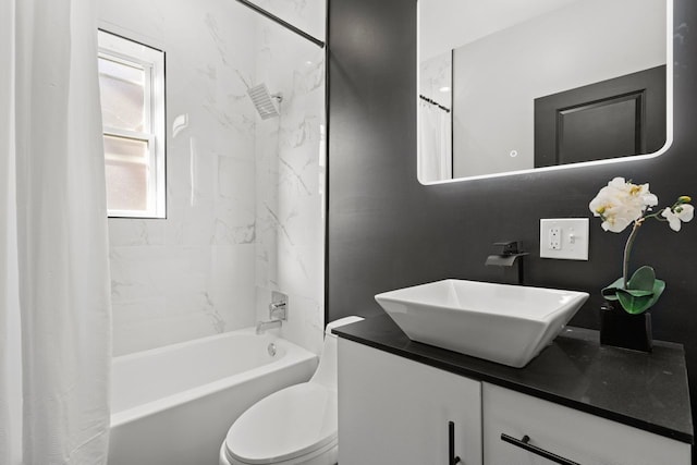 full bathroom with shower / tub combo, vanity, and toilet