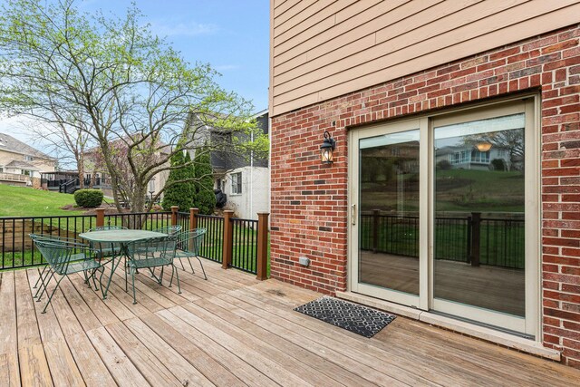 wooden terrace with outdoor dining space