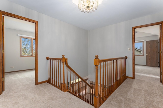 stairs featuring carpet flooring and baseboards