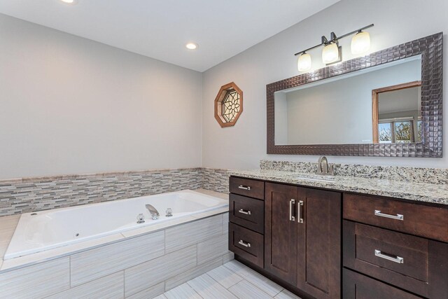full bathroom with a whirlpool tub, recessed lighting, tile patterned floors, and vanity