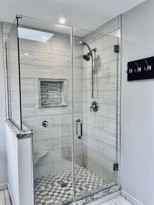 full bath featuring a shower stall, recessed lighting, and baseboards