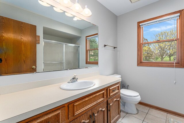 full bathroom featuring tile patterned floors, a shower stall, toilet, vanity, and baseboards
