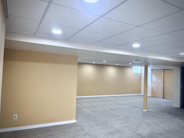 basement featuring baseboards and carpet floors