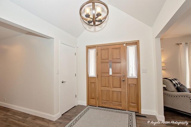 entrance foyer featuring dark hardwood / wood-style flooring and vaulted ceiling