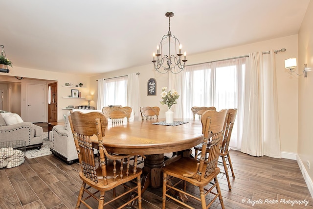 dining area featuring dark hardwood / wood-style floors and a chandelier