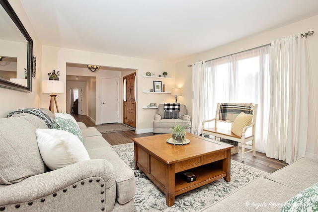 living room with an inviting chandelier and light wood-type flooring