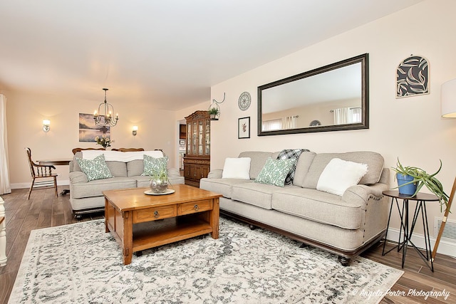 living room featuring hardwood / wood-style floors and an inviting chandelier