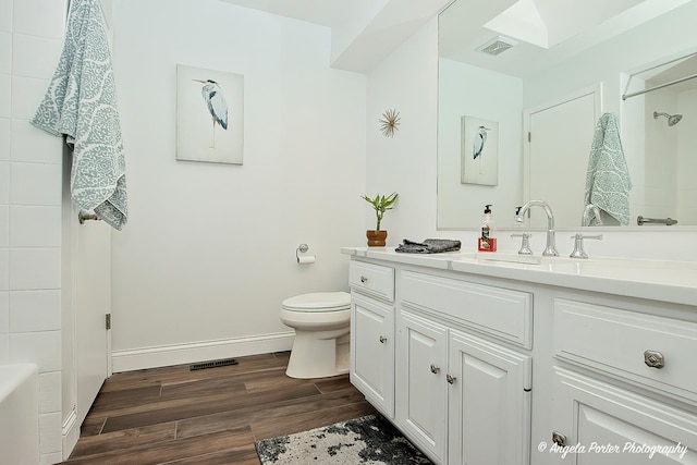 full bathroom with hardwood / wood-style flooring, vanity, toilet, and bathing tub / shower combination